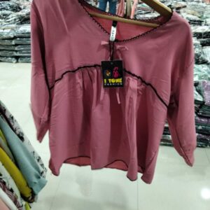 Women's mauve pink babydoll tunic with black scalloped trim and neckline ribbon tie.