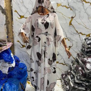Ivory floral print kaftan with butterfly sleeves, crystal waist embellishment, and matching hijab on a mannequin.