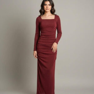 Woman wearing a long-sleeve maroon glitter maxi dress with a square neckline and side ruching.