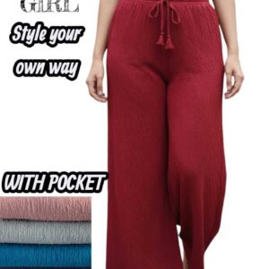 Woman wearing crimson red wide-leg lounge pants with a crinkle texture, side pockets, and tassel drawstring.
