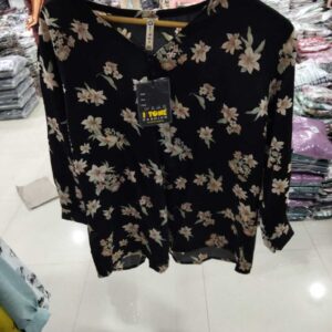 Women's dusty rose pink blouse with white magnolia floral print and silver ring hardware at the neck.