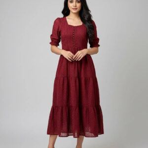 Woman wearing a burgundy tiered midi dress with puff sleeves and button-down bodice.