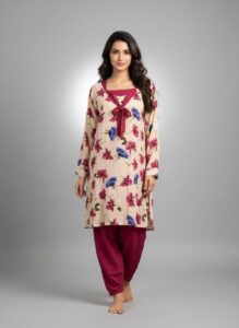 Woman wearing a cream-colored long-sleeve kurti with pink and blue floral prints and matching magenta trousers.