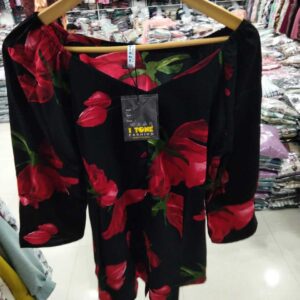 Women's black off-the-shoulder top with large vibrant red rose print and sweetheart neckline.