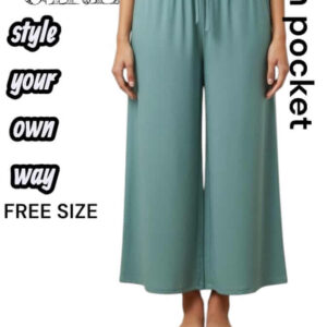 Woman wearing sage blue Valentino smooth wide-leg lounge pants with a drawstring waist and side pockets.
