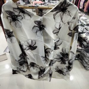 Women's antique white long-sleeve top with large black floral sketches and a side pearl-button asymmetric wrap front.