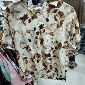 Women's cream-colored blouse with mocha brown floral print and button-down front.