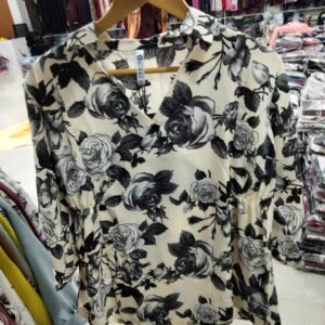 Women's ivory and black floral surplice top with rose print and cinched waist.